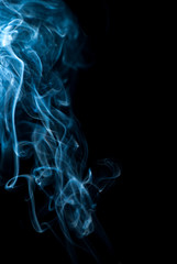 Beautiful smoke on the black background - macro photo. The concept of incense in the apartment. Isolated on black background overlay for your needs