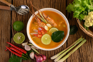Tom Yum Kung Thai hot spicy soup shrimp with lemon grass,lemon,galangal and chilli on wooden background Thailand Food