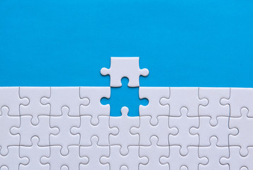 Jigsaw puzzle white color,Puzzles pieces grid,Success mosaic solution template,Horizontal on blue...