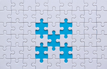 Jigsaw puzzle white color,Puzzles pieces grid,Success mosaic solution template,Horizontal on blue color background copy space for text,Top view