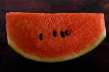 Sliced ​​watermelon on a wooden table.