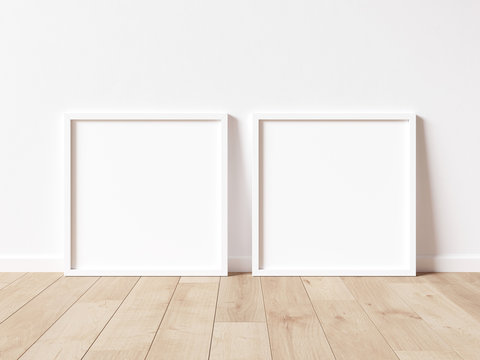 Two square white frame mock up on wooden floor with white wall. 3D illustrations.