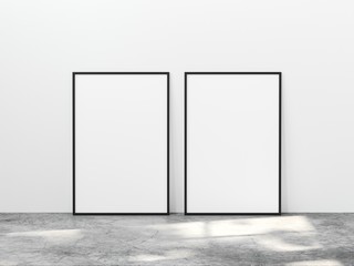 Two vertical black frame mock up on concrete floor with light overlays. Set of two black frame mock up poster. Two vertical frame 3d illustrations.