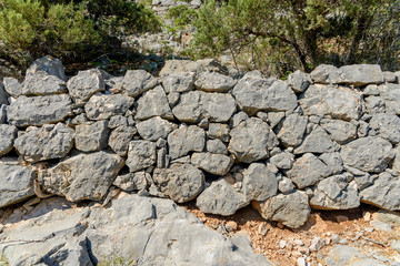Stone wall made of mountain, natural stone, folded without cement.
