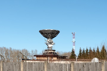 Mirror satellite dish of the Orbita ground-based transceiver station against a blue sky in autumn. © papava