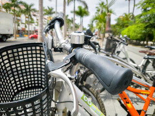 Closeup image of ringing bell and basket on the bicycle parked on street