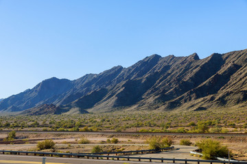 Fototapeta na wymiar Mountains along desert and blue sky in the landscape of Arizona, USA