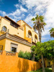 Beautiful photo of beautiful spanish colonial building and high palms in the garden