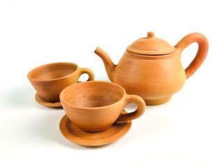 Brown clay teapot and teacups, isolated on white background
