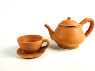 Brown clay teapot and teacup, isolated on white background