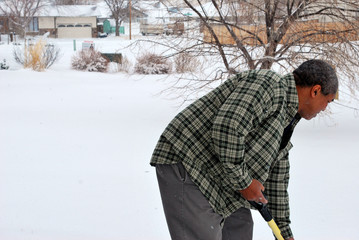 Man shoveling winter snow outside.