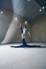 The women sat down on the twine. classes in the fitness club. the two girl is engaged in recreational gymnastics. sports exercises and stretching: athletics