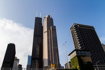 Bottom view of modern office buildings in financial district at sunset, real estate and success concept, USA