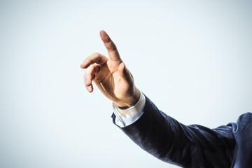 Businessman hand touching abstract tranparent screen, isolated on blue background. Business and...