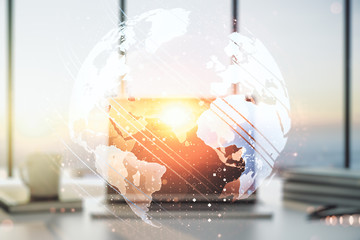 Abstract creative world map on modern laptop background, international trading concept. Multiexposure