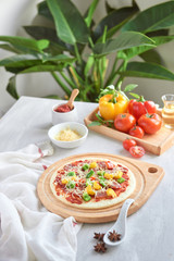 Raw pizza dough with tomato sauce, ingredients