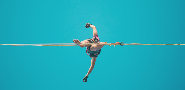 Highliner on the background of blue sky.