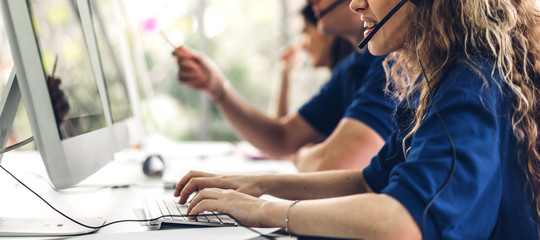 Group of happy smiling business operator customer support team phone services working with headset...