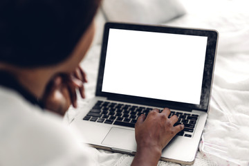 Young african american black woman relaxing and using laptop computer with white mockup blank...
