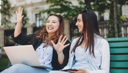 Charming plus sized woman telling future plans to her caucasian sister with black hair and nice...
