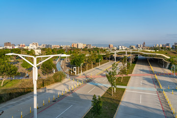 Fototapeta premium Street view of Shuinan Economic and Trade Area in blue sky sunny day. Former Shuinan Airport, lot of green space in here. Xitun District, Taichung City, Taiwan