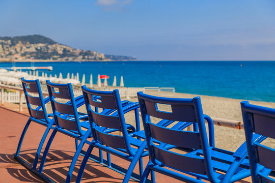 Blue chairs on the Promenade des Anglais in Nice France