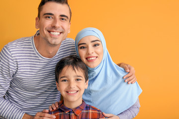 Fototapeta premium Portrait of Muslim family on color background