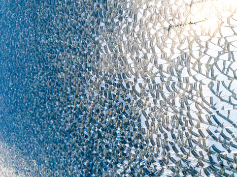 Macro image of mirror or glass surface shattered in small pieces