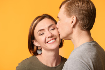 Portrait of beautiful couple on color background