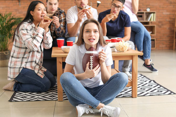 Group of fans watching rugby on TV