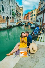 Poster couple having date at pier with beautiful view of venice canal © phpetrunina14