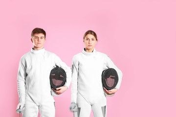 Young fencers on color background
