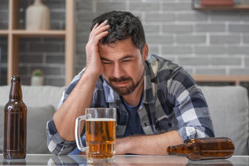 Man drinking beer at home. Concept of alcoholism