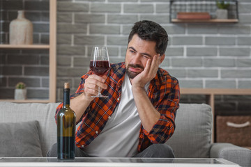 Man drinking wine at home. Concept of alcoholism
