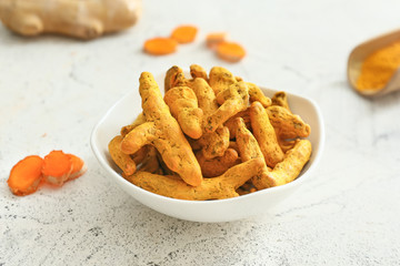 Bowl with aromatic turmeric on table