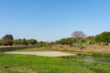 Obraz premium Taichung Central Park at the Shuinan Economic and Trade Area in blue sky sunny day. Former Shuinan Airport, lot of green space in here, the second largest park in Taiwan. Xitun District, Taichung City