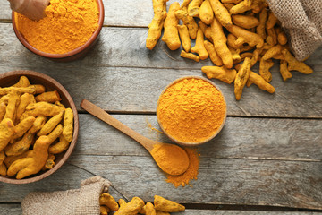 Composition with aromatic turmeric on wooden background