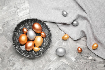 Plate with beautiful Easter eggs on table