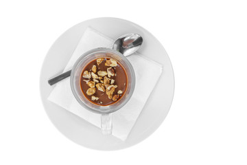 Cocoa, hot chocolate with walnuts in a high glass glass, on a plate with a teaspoon and napkins, view from above, isolated white background
