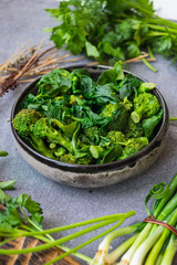 Obraz na płótnie Canvas Green cooked steamed broccoli, spinach salad meal. Vegan healthy diet food.