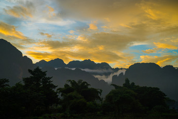 Silhouette of hills by the river at sunset. Stunning twilight sky at blue hours