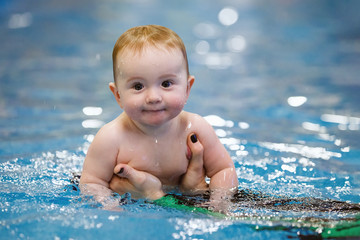 Fototapeta na wymiar Toddler swim in water pool.