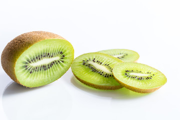 Kiwi fruit half and slices isolated on white background with selective focus