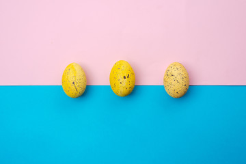 Yellow, easter eggs on a pink-blue background