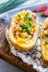 Baked stuffed potato with vegetables inside. Herbs, corn, tomato paste. Vegan healthy diet food. Inspiring and vibrating organic lunch, dinner. No cheese or diary products.