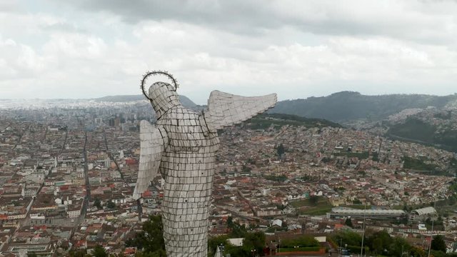 4k drone footage of city of Quito, Ecuador, and metropolitan area, in one picture with famous statue of the madonna statue "Virgen de El Panecillo".