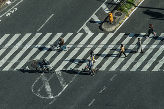 Motion blurry pedestrians crossing zebra crossing in Japan