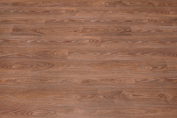 Fototapeta premium Natural dark brown wooden surface floor texture background. polished laminate parquet