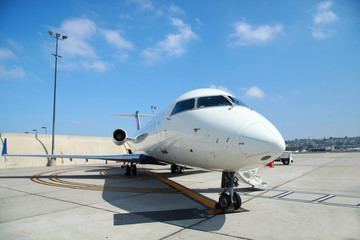 Fototapeta na wymiar Small commercial plane parking in sunny day