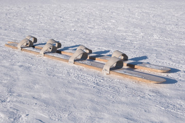 Old wooden ski with multiple leather foot loop for four people to walk together